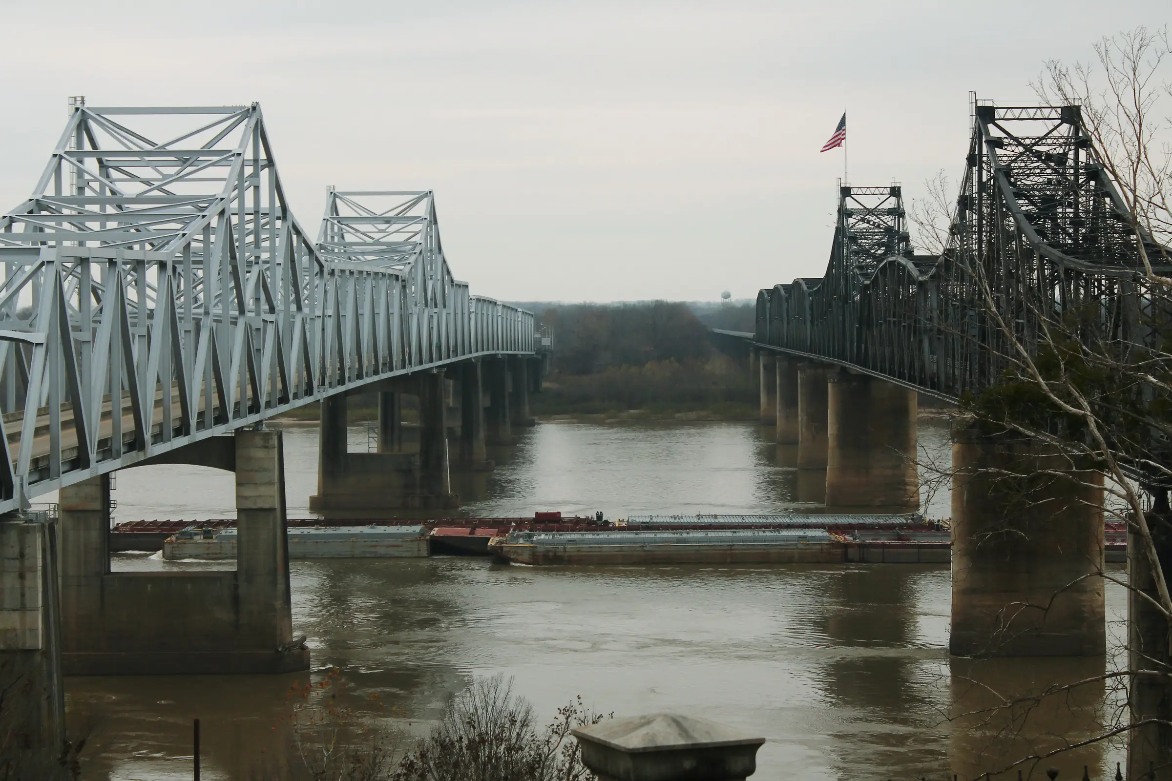 The Mississippi River bridges at Vicksburg, with a barge passing under them